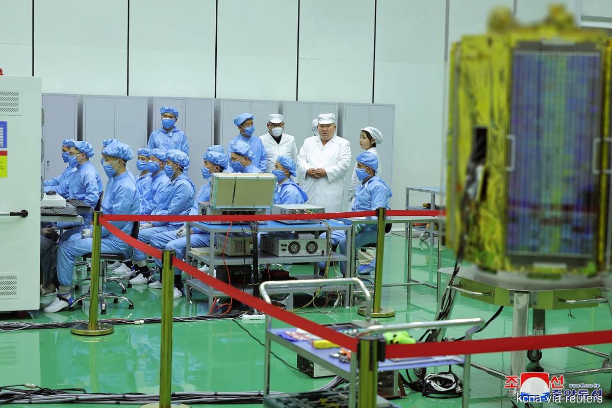 North Korean leader Kim Jong Un and his daughter Kim Ju Ae meet with members of the Non-permanent Satellite Launch Preparatory Committee, as he inspects the country’s first military reconnaissance satellite, in Pyongyang, North Korea on May 16, 2023, in this image released by North Korea’s Korean Central News Agency on May 17, 2023. (Photo credit: KCNA via Reuters)